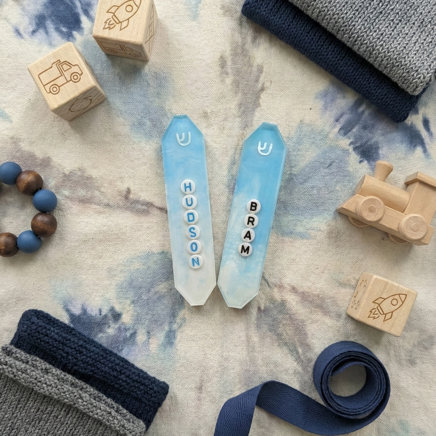 two personalized powder blue and white mezuzahs